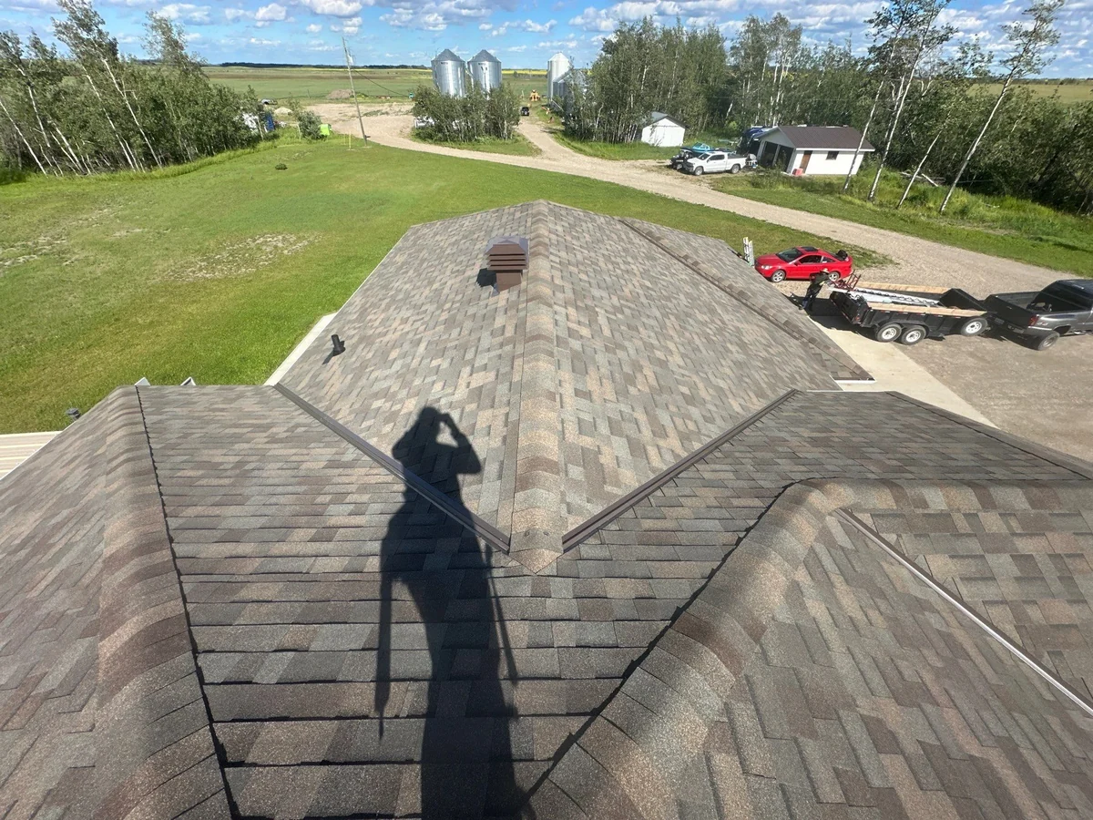 Shingle roof ridges overlooking a rural property