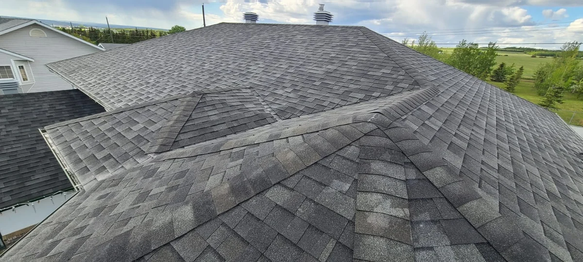 Roof valley and intersecting asphalt shingle roof slopes