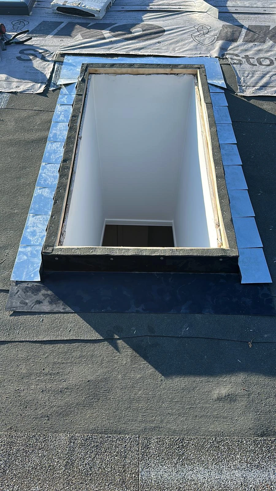 Flashing around a roof opening during skylight installation
