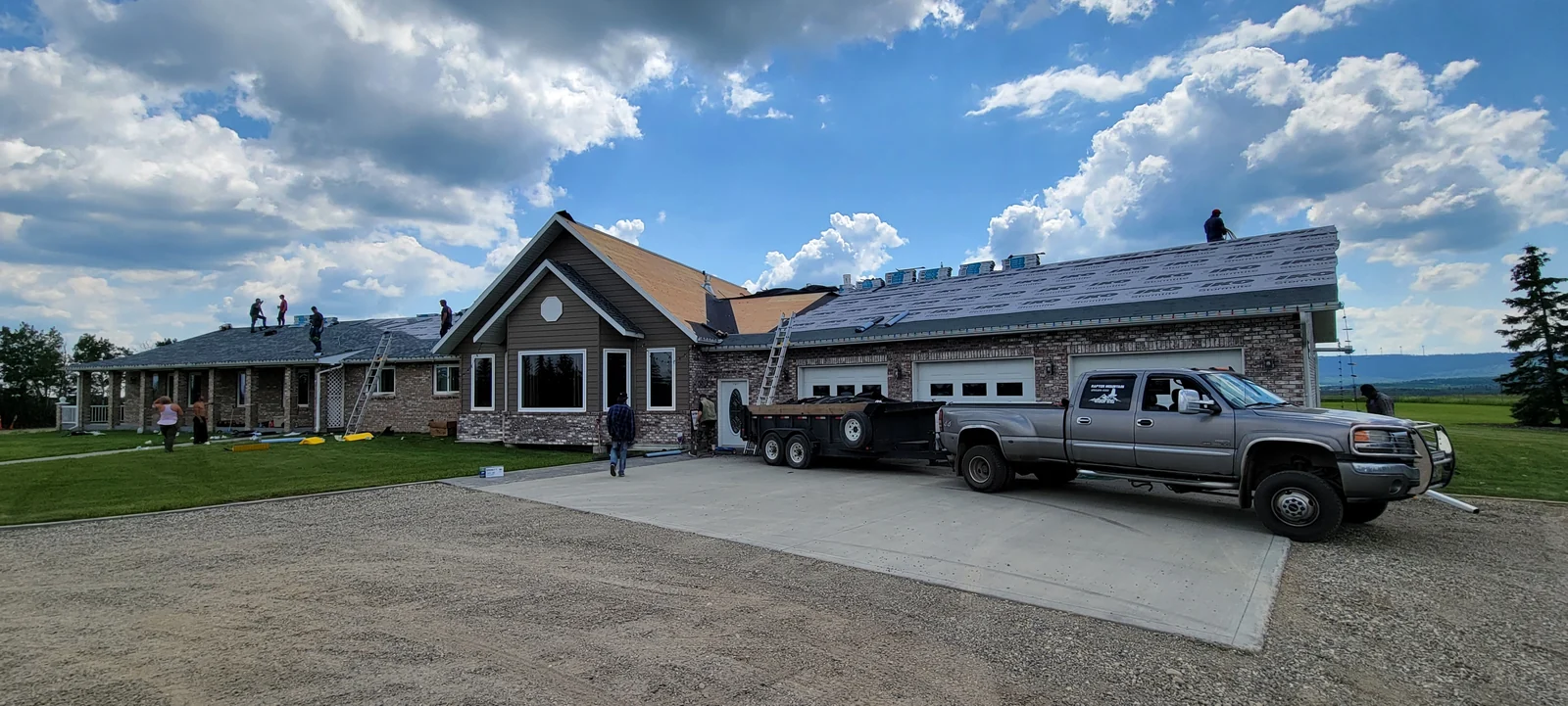 Roof replacement underway on a house with a three-car garage